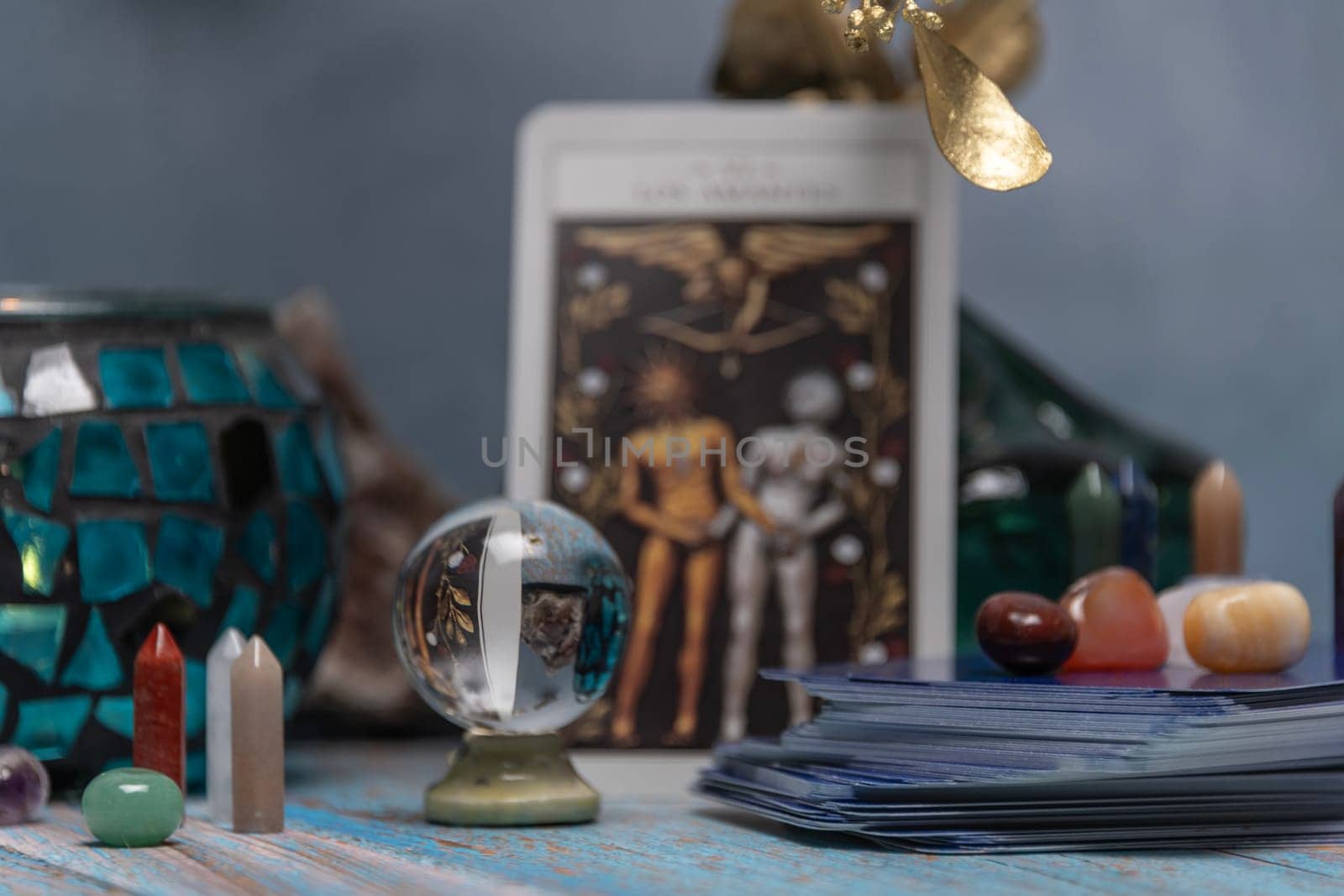 Cartomancy - Pendulum On Blurred Altar With Defocused Tarot Cards