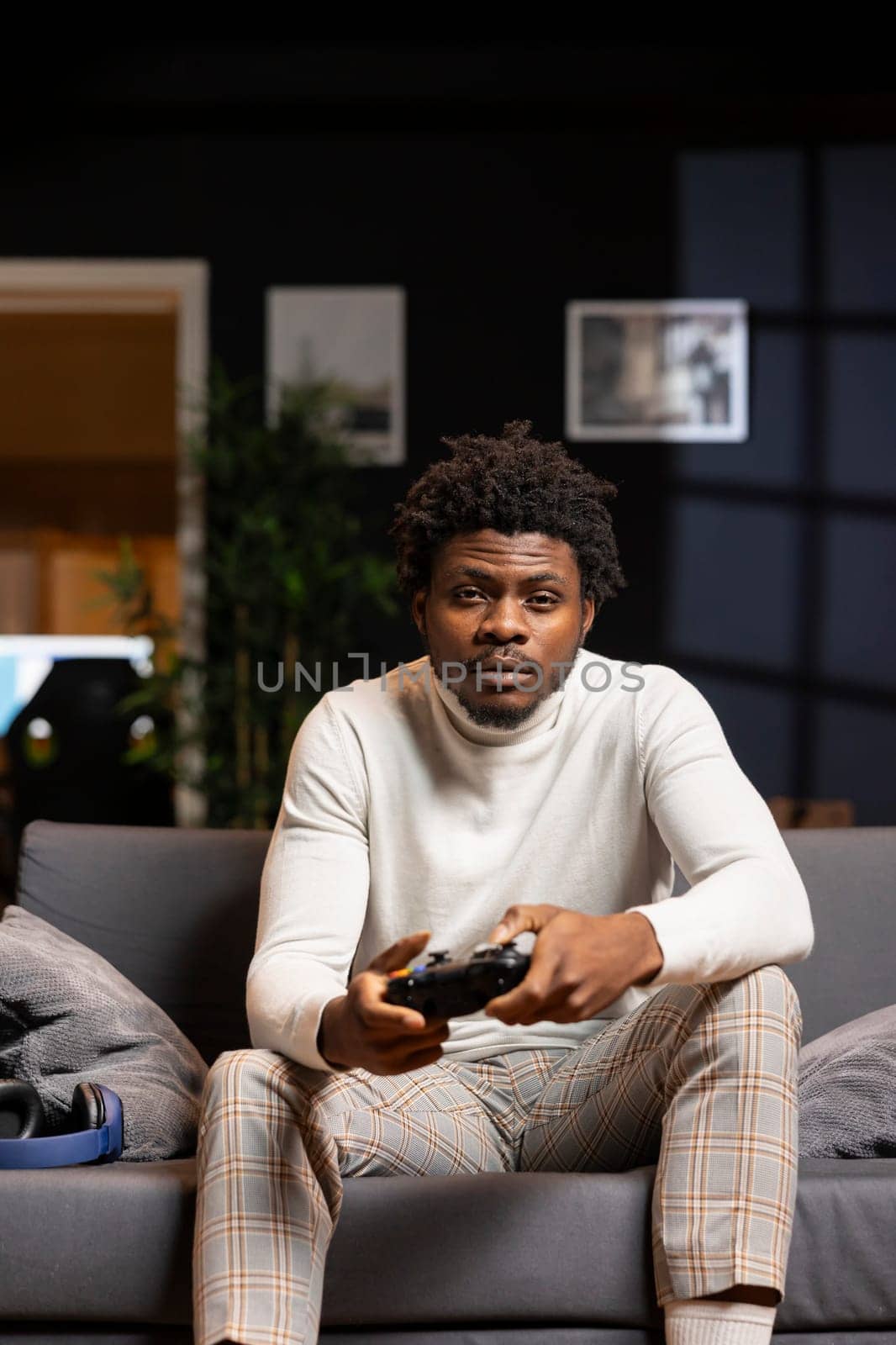 Portrait of man playing boring videogame on gaming console by DCStudio