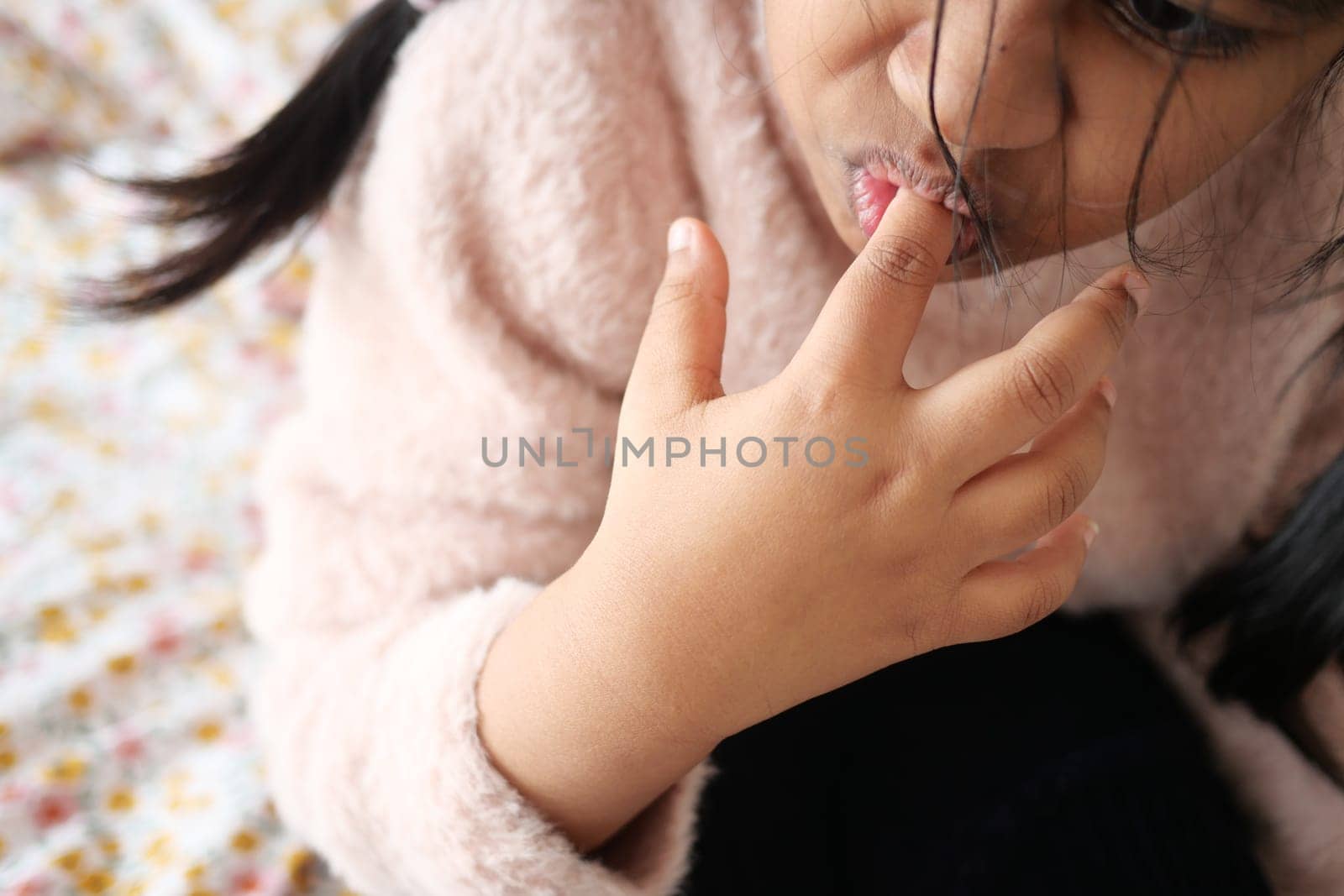 child girl biting her nails at home, by towfiq007