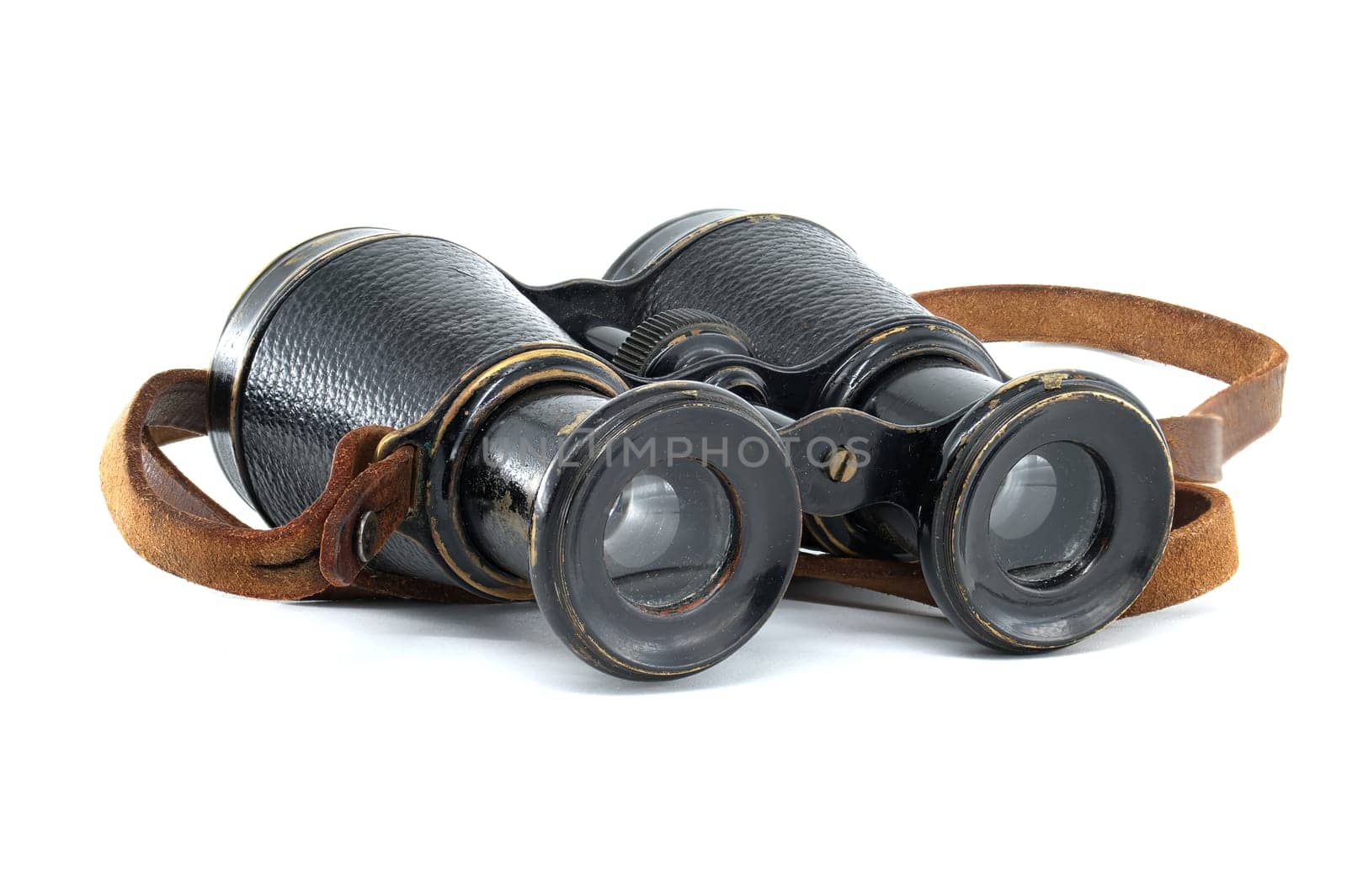 Ancient pair of black binoculars with brown leather straps isolated on white background