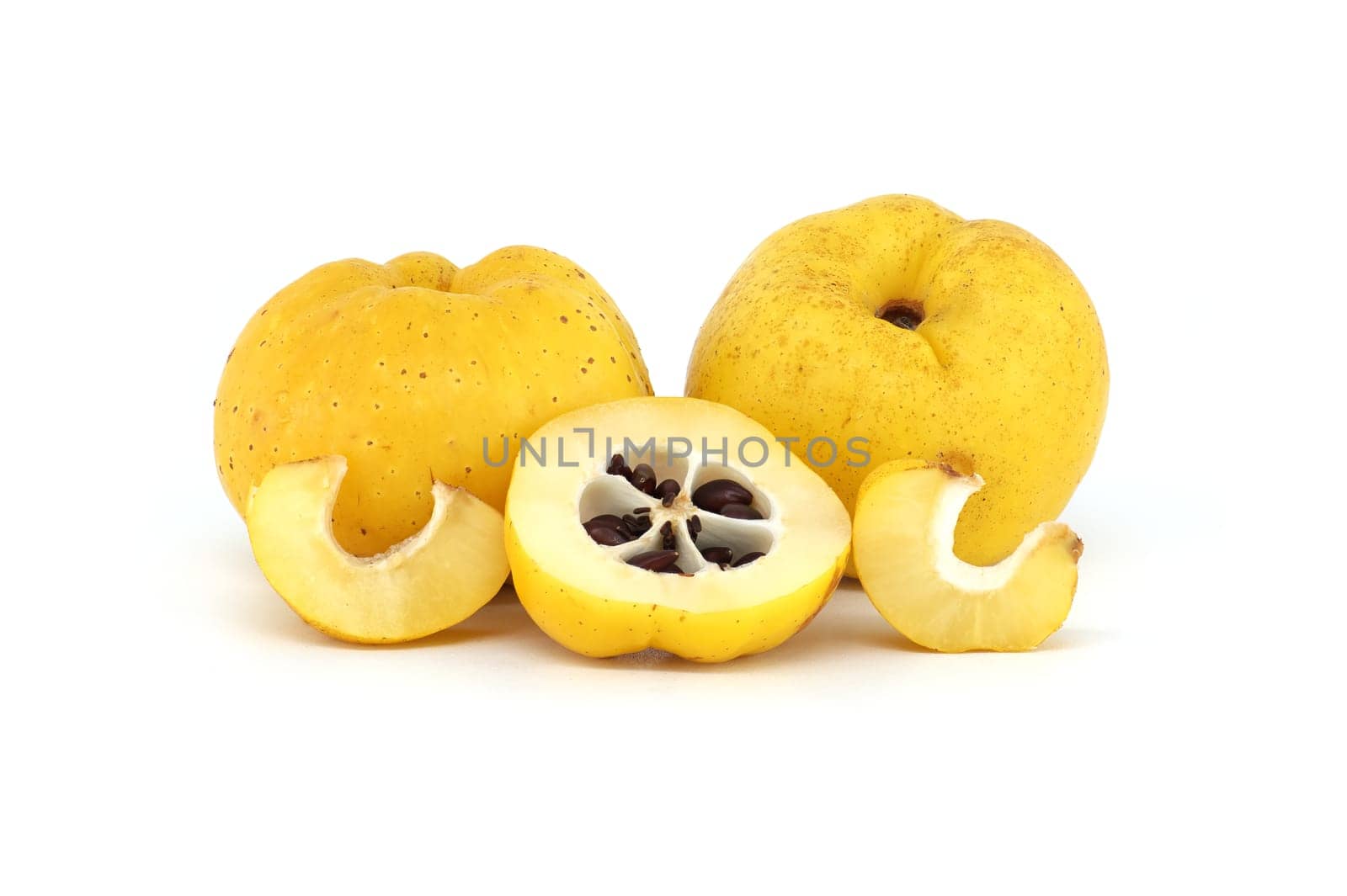 Vibrant quince fruits, both sliced and whole isolated on white background, full depth of field, Chaenomeles japonica or Japanese quince