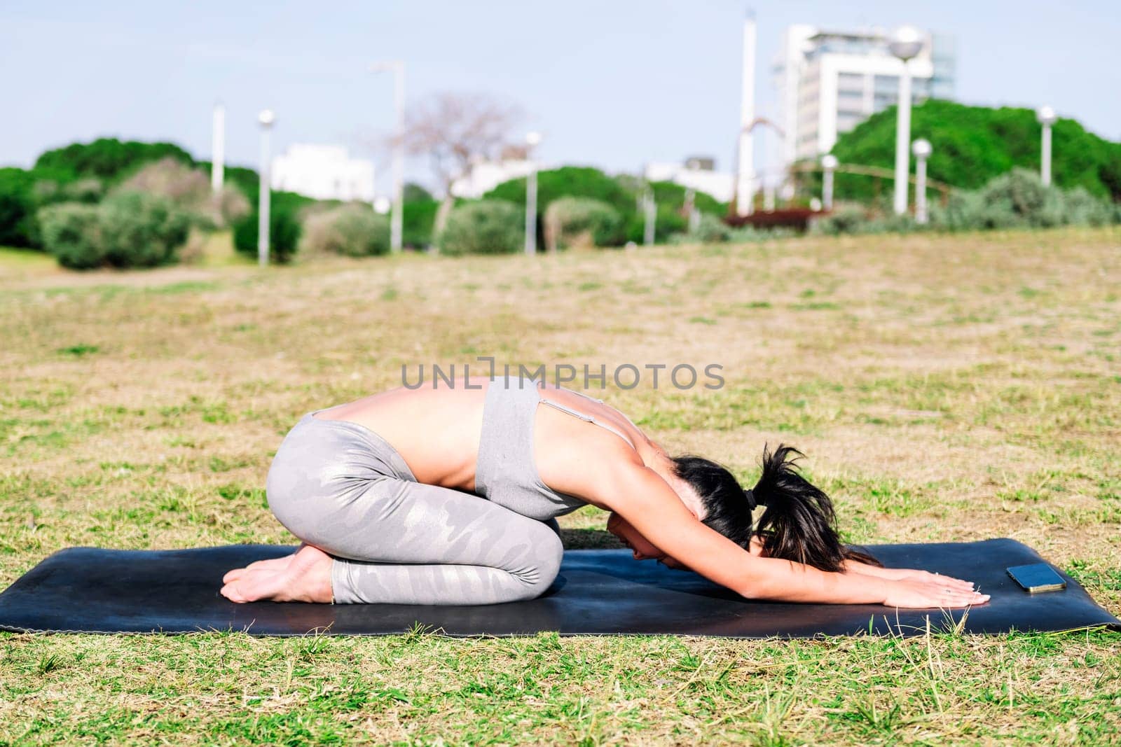 young woman doing yoga back stretching exercises by raulmelldo