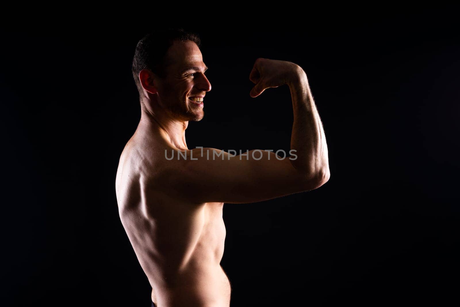 Portrait of man, bodybuilder and bicep flex in studio, background and exercise for muscular power. by Zelenin