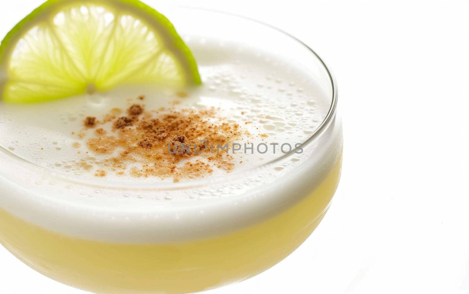 Close up of pisco sour cocktail drink isolated on white background by papatonic