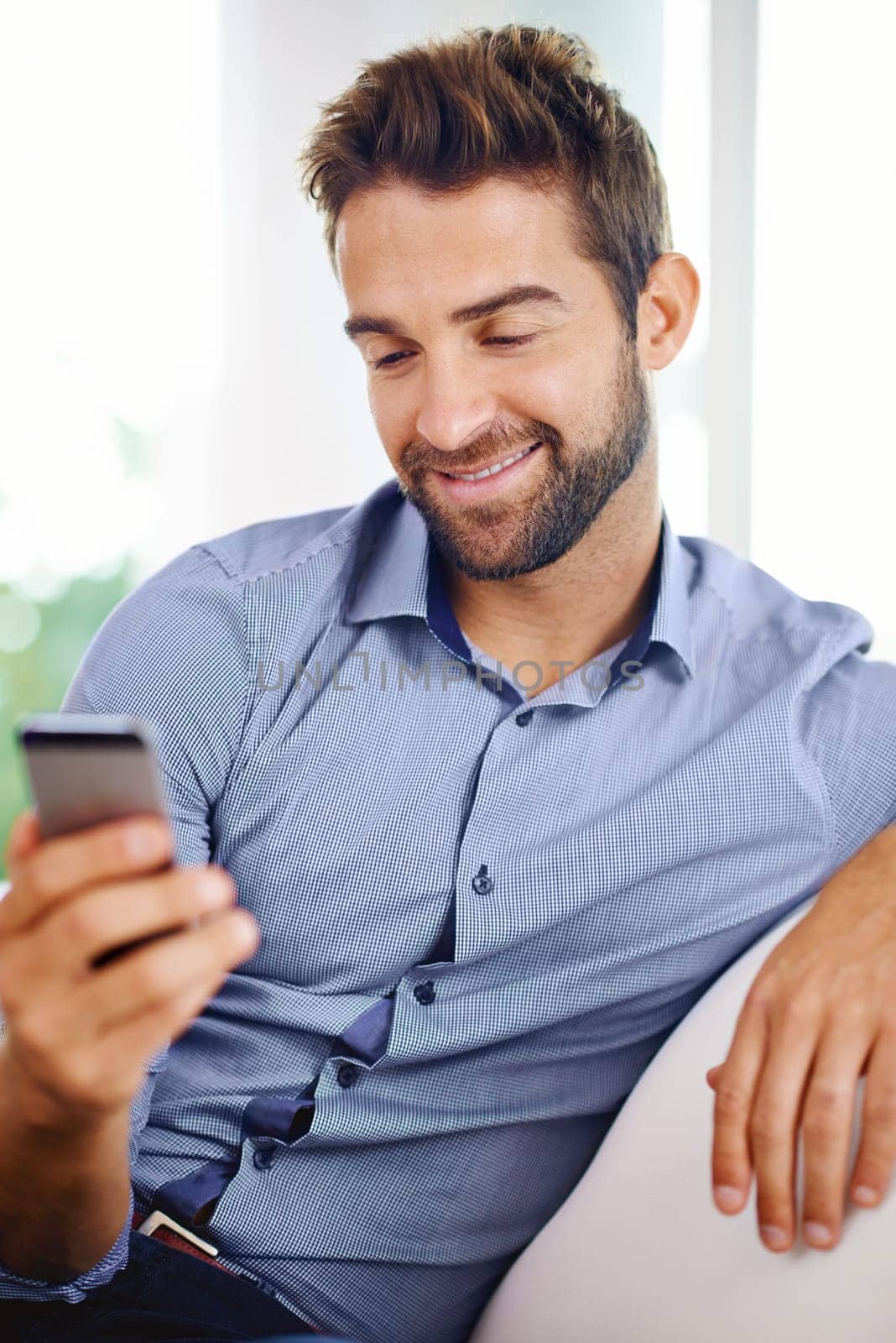 Businessman, phone and reading an email in home, communication and networking for company. Happy male person, smile and notification on app for conversation, website and internet for information by YuriArcurs