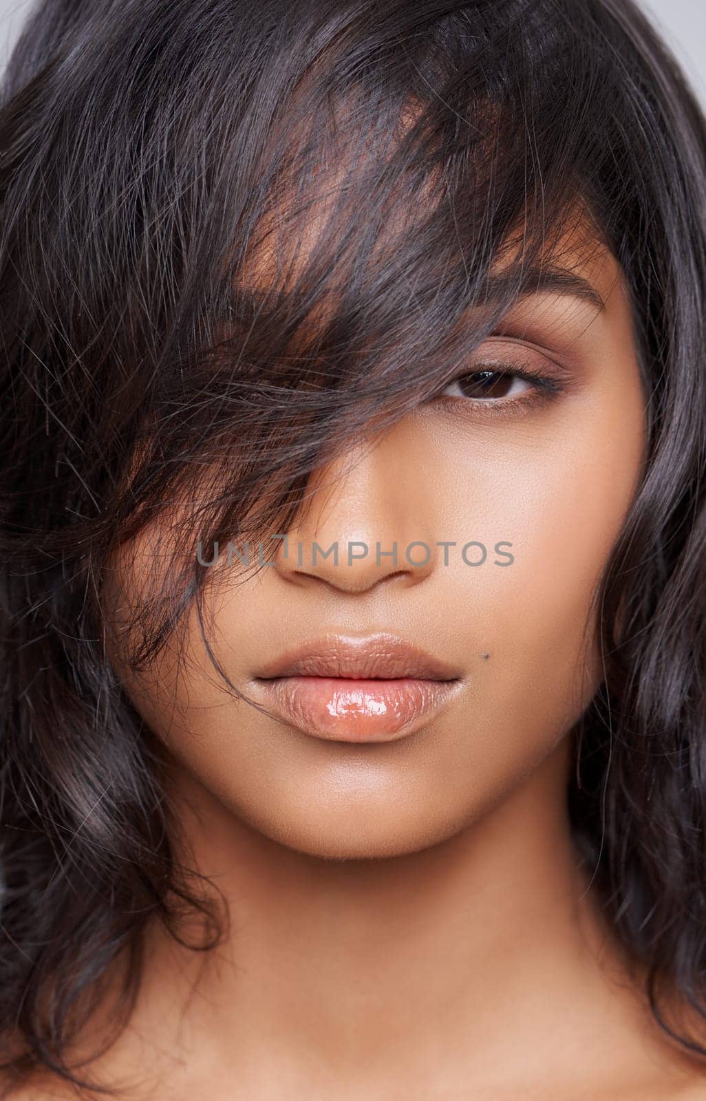 Woman, hair and beauty in portrait with hairstyle, salon treatment for texture and growth on grey background. Face, haircare and wellness for shine, cosmetology and change with cosmetics in studio by YuriArcurs