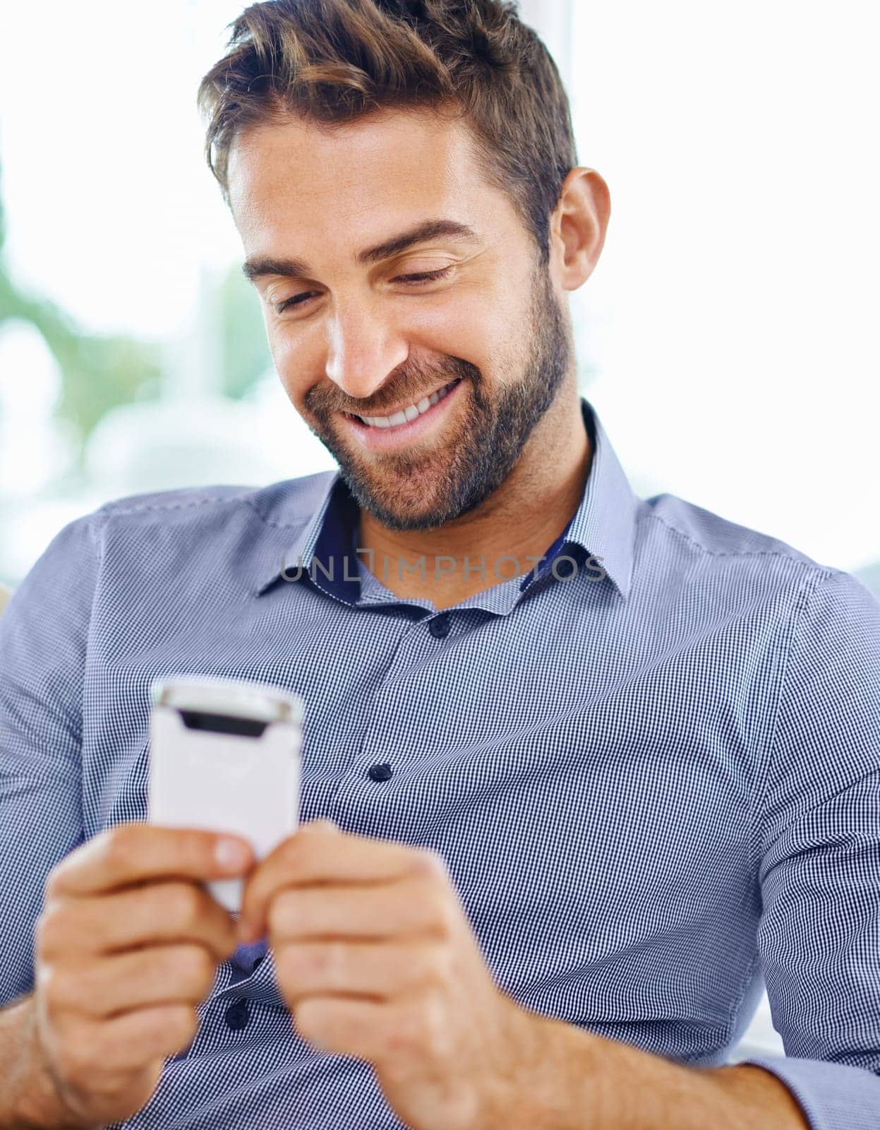 Business man, phone and check an email in home, communication and networking for company. Male person, smile and reading a notification on app for conversation, website and internet for information by YuriArcurs
