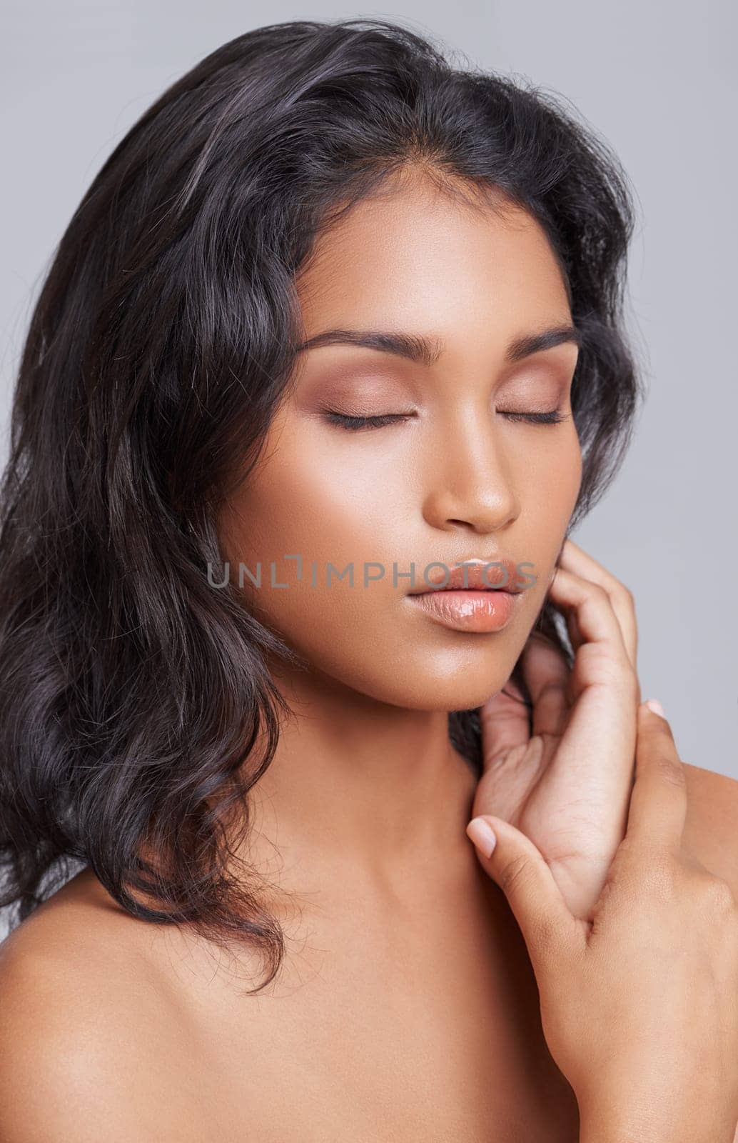 Woman, hair and eyes closed for beauty with hairstyle, salon treatment for texture and growth on grey background. Face, haircare and peace for shine, cosmetology and change with cosmetics in studio.