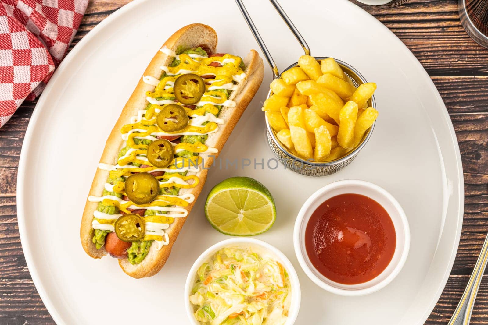 Delicious hot dog sandwich with sauces and fries on the side by Sonat