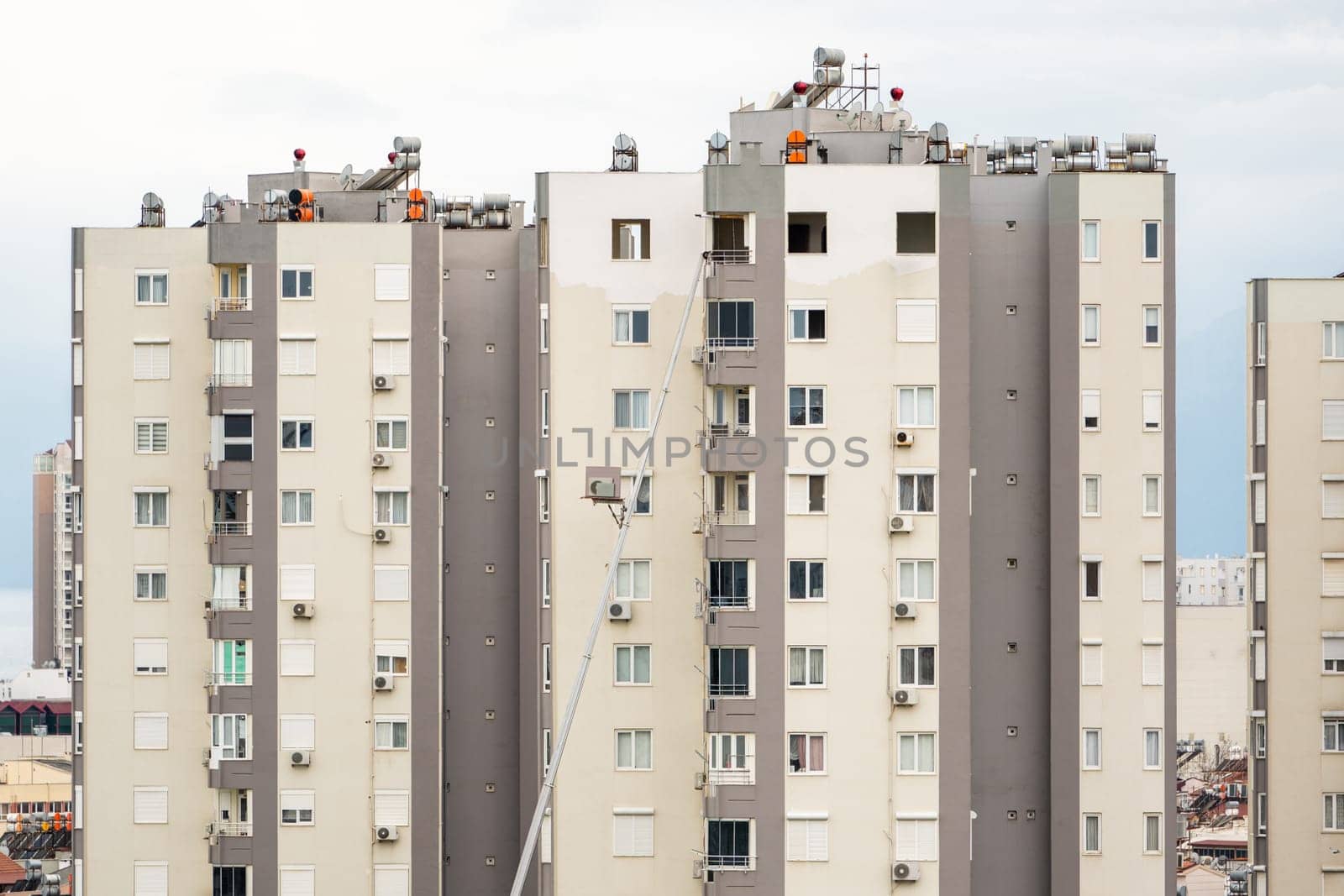 Home removal with hydraulic lift. Transporters carrying goods by elevator from the window of the building