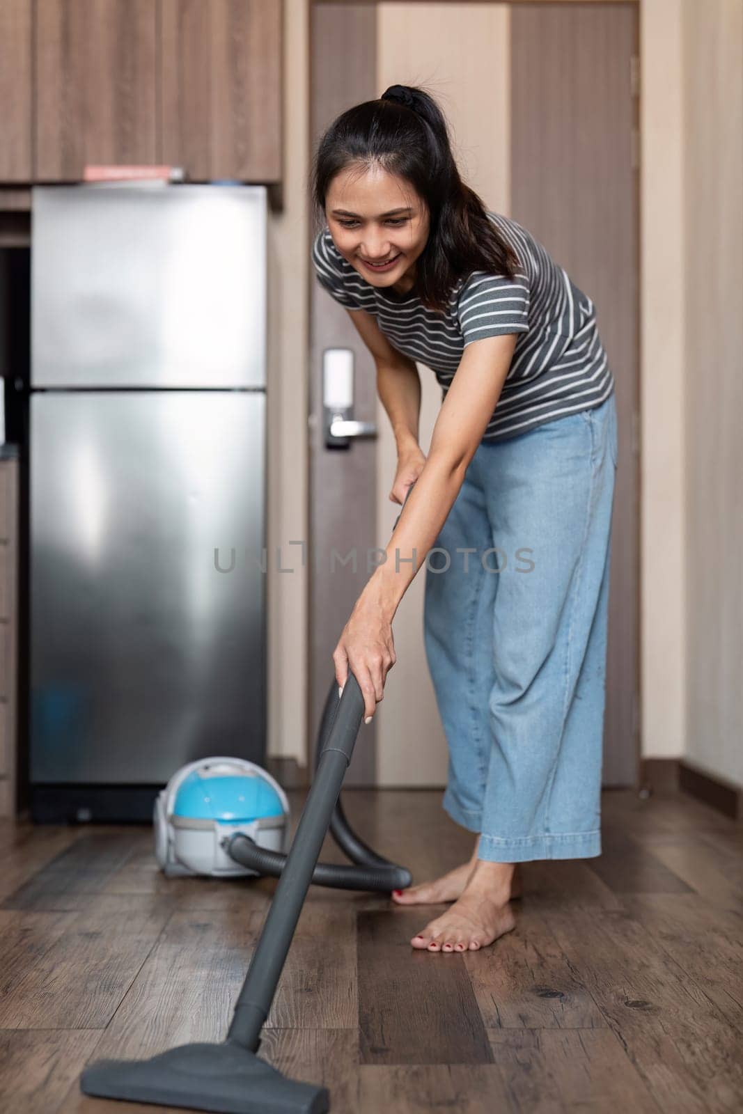Young woman asian cleaning floor with vacuum cleaner in living room, Housework, cleanig and chores concept.