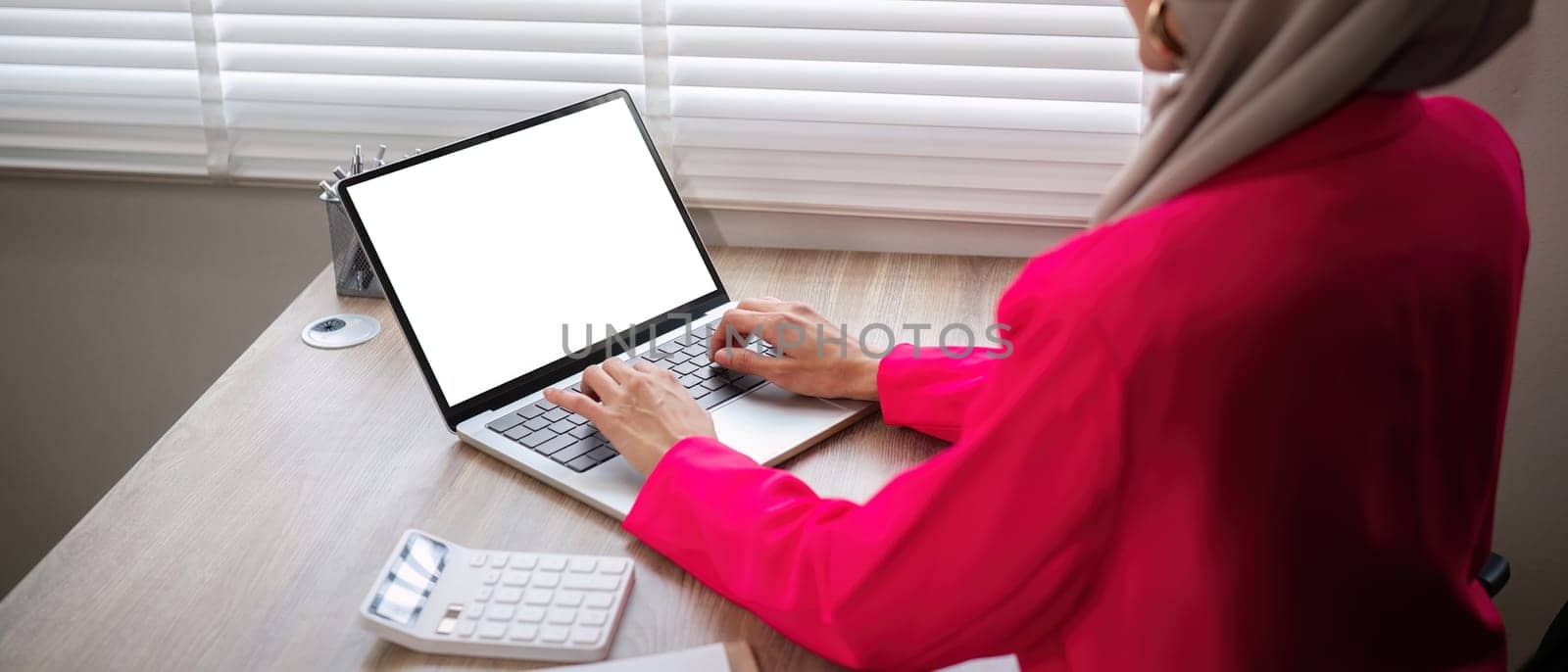 Muslim businesswoman while working with laptop, Empty screen of laptop, Business and financial concept.