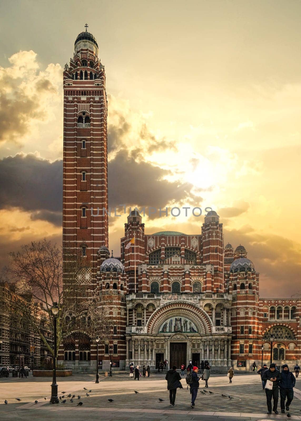 London, United Kingdom - February 02, 2019: People walking in front of Westminster Cathedral on cold day with nice afternoon clouds. It's the main catholic church in England and Wales consecrated 1910 by Ivanko