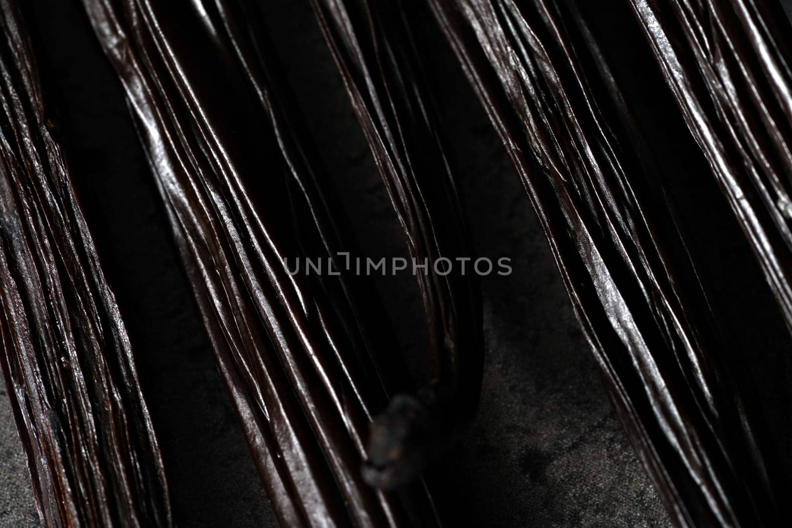 Vanilla beans on dark gray board - abstract close up macro detail with shallow depth of field