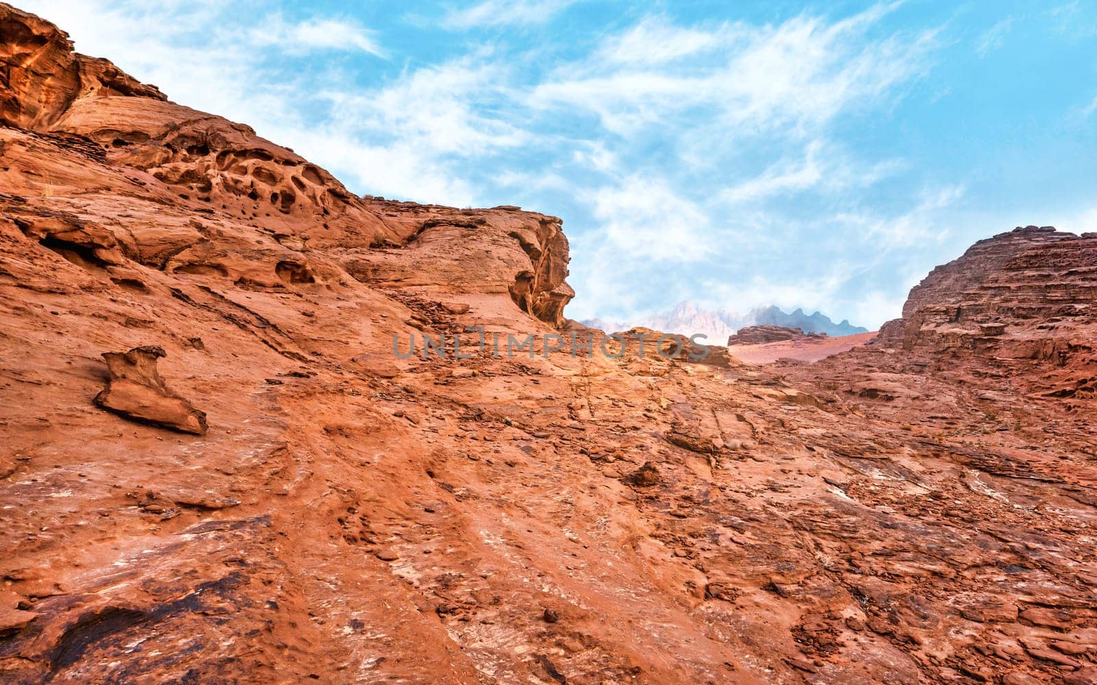 Red rocks and dust in Wadi Rum, Jordan desert - landscape that looks as different planet or science fiction movie set by Ivanko