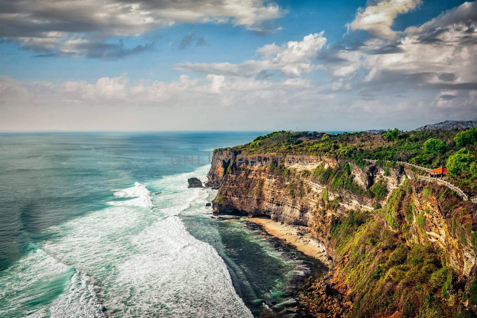 Cliff in ocean on sunset in Uluwatu, Bali, Indonesia