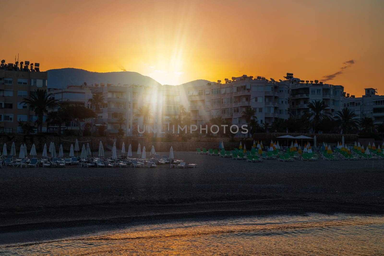 Beautiful sunrise scene on Alanya beach with view to famous Alanya island, in Turkey