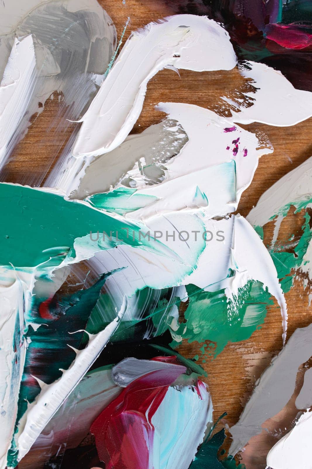 Fragment of multicolored texture painting on plywood. Abstract art background. oil on canvas. Rough brushstrokes of paint. Closeup of a painting by oil and palette knife. Highly-textured, high quality details.