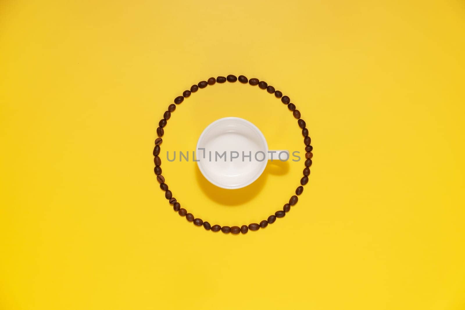 Empty coffee cup and coffee beans on yellow background by NataliPopova