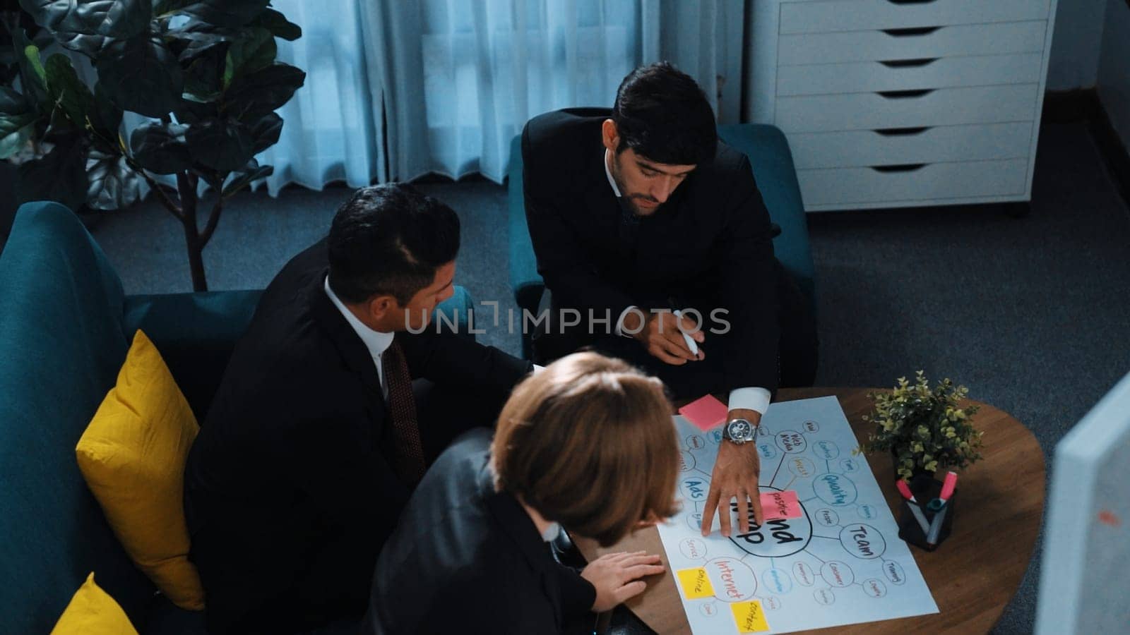 Top view of skilled businessman write marketing idea and drawing mind map while project manager explain financial strategy at meeting room. Professional startup team brainstorm idea. Directorate.