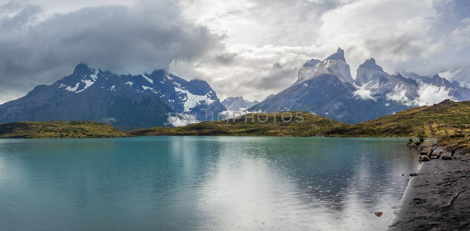 Mountain range reflected in calm lake for peaceful scenery.