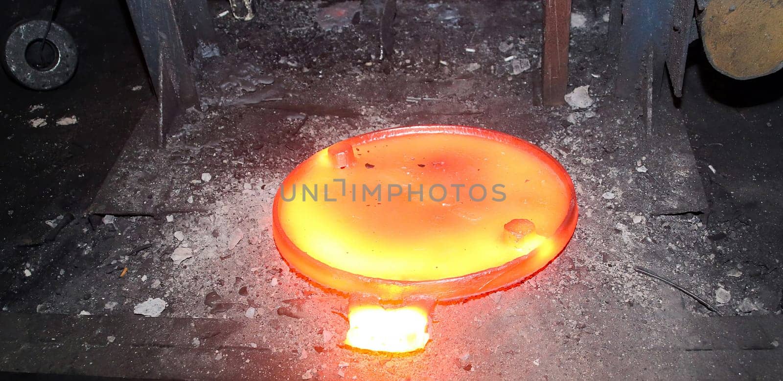 Press for forging glowing metal discs, sewer manholes isolated on black background. by Hil