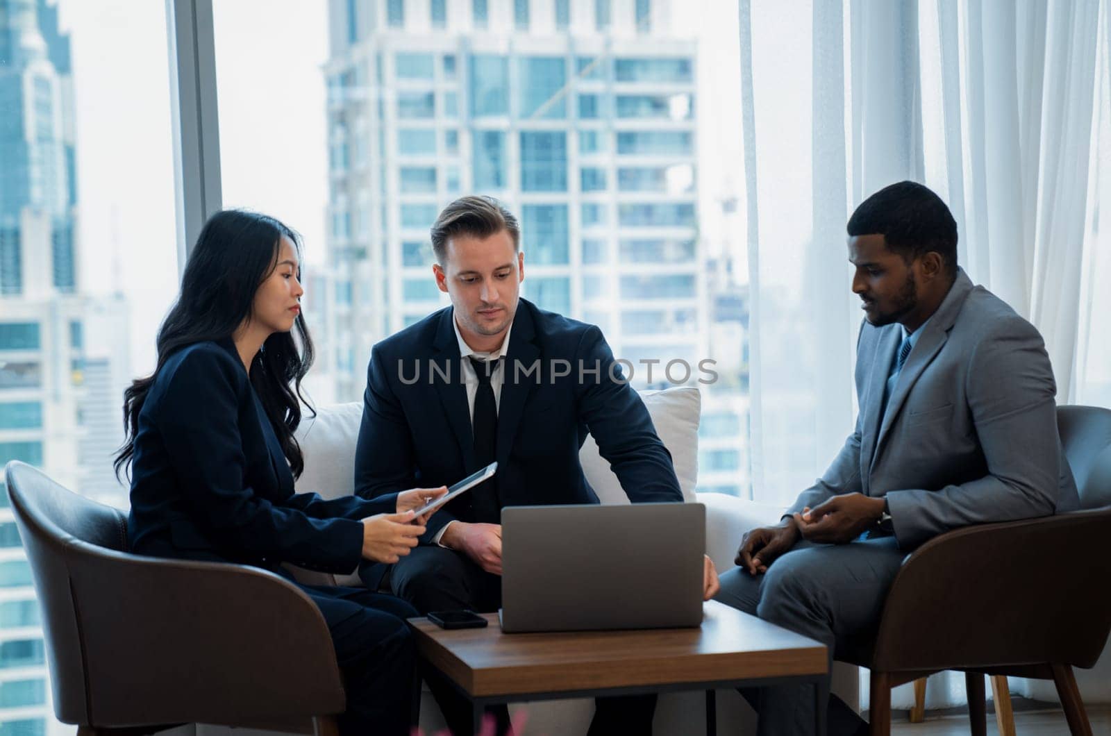 Young smart businesswoman showing data analysis to diverse investor by using tablet. Multicultural business group discussing and investing in start up project. Modern office. Meeting. Ornamented.