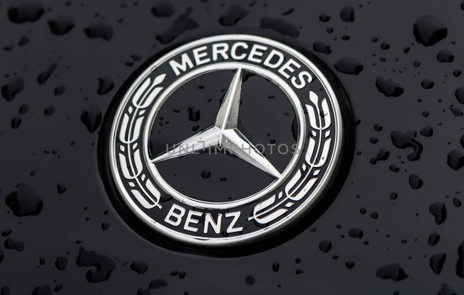 Chernigov Ukraine 13.03.2024-Close-up of the blue round Mercedes Benz logo on the hood of a black car 2 by Mixa74