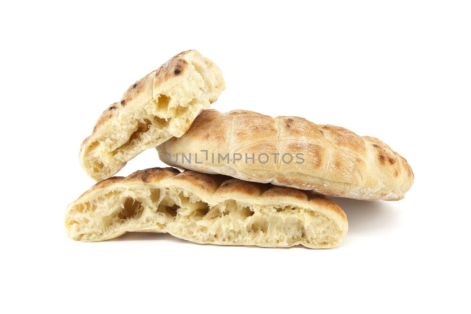Stack of round pita flat-breads isolated on a white background, pita bread has a pocket and is cut open, showcasing their soft interior