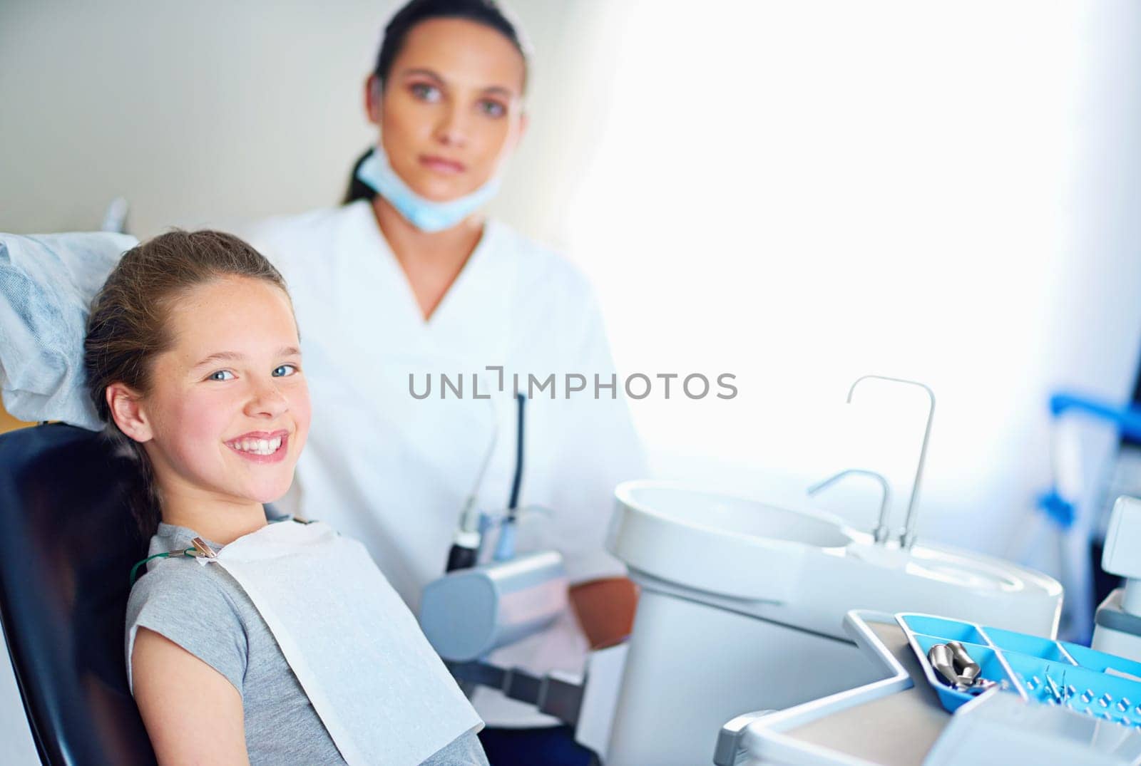 Dentist, clinic and portrait of child with smile for cleaning, teeth whitening and wellness. Healthcare, dentistry and woman and girl with tools for dental hygiene, oral care and medical services by YuriArcurs