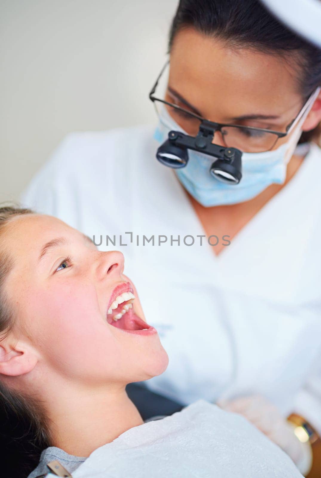 Dentist, consultation and woman with girl, kid and checkup for teeth whitening and oral healthcare. Professional, child and patient with medical procedure and appointment with dental hygiene or trust by YuriArcurs