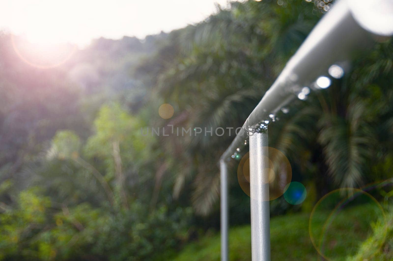 Close up view of stainless steel staircase hand with wonderful nature view.