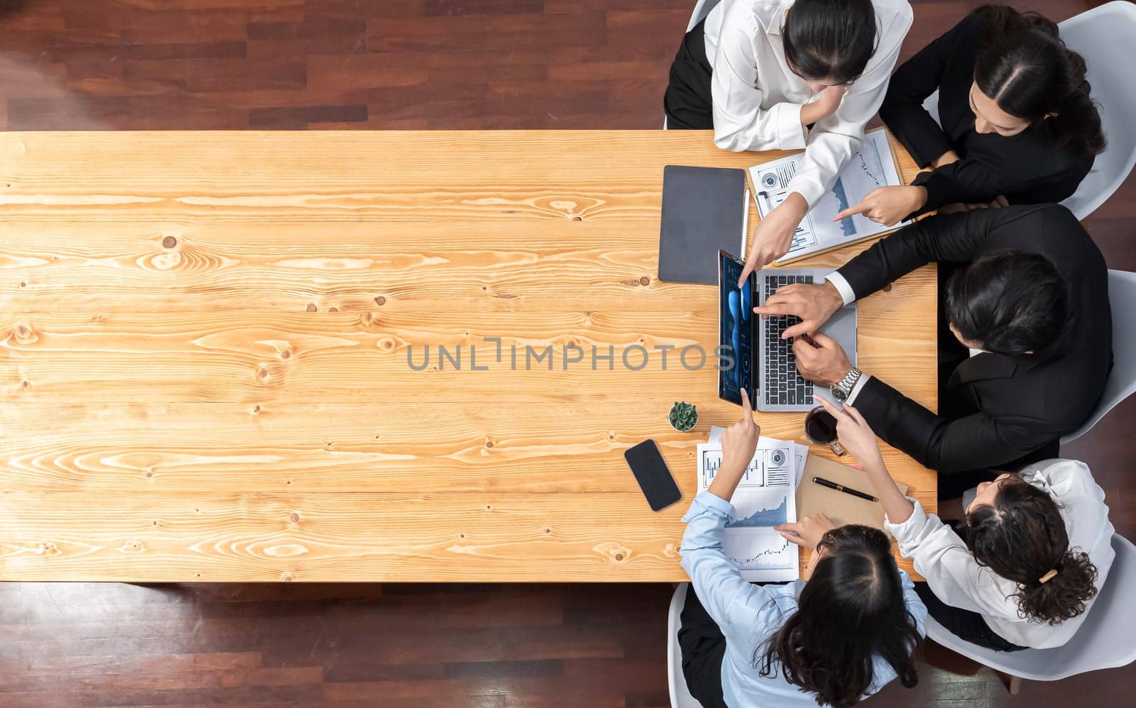 Panorama top view diverse group of business analyst team analyzing financial data report paper on meeting table. Chart and graph dashboard by business intelligence analysis. Meticulous