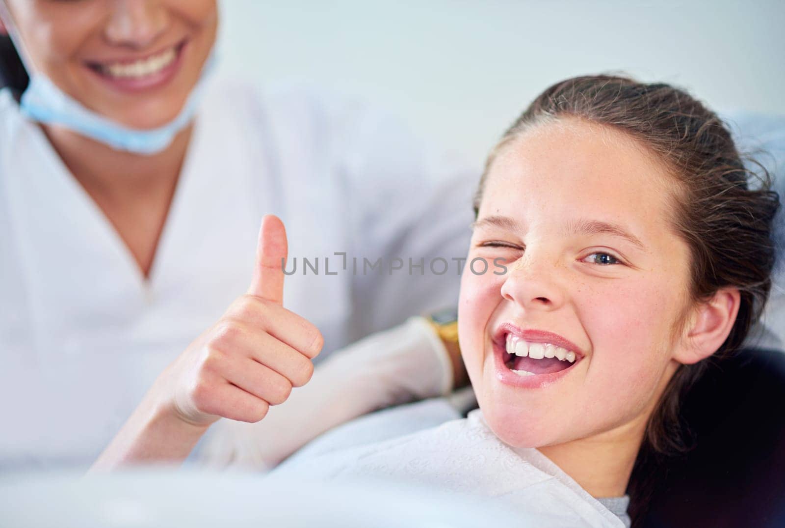 Dentist, child and portrait with thumbs up with teeth cleaning or cavity treatment for oral hygiene, healthy or whitening. Female person, face and hand gesture for happy consultation, dental or yes by YuriArcurs