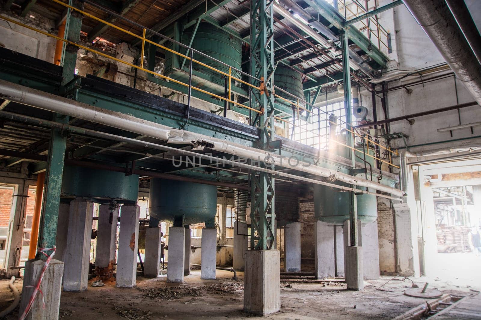 A large industrial building with a lot of pipes