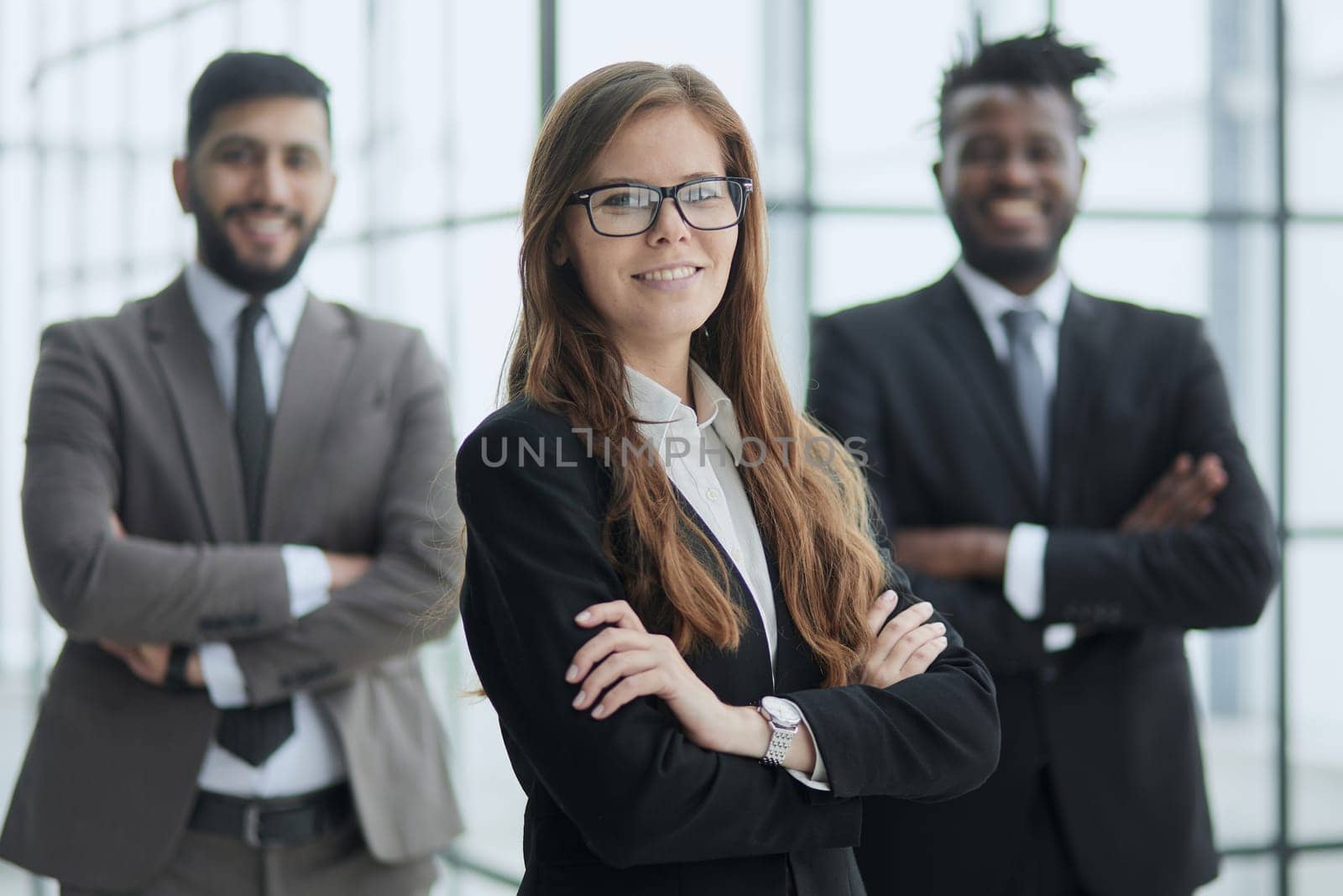Beauty and men. three office workers are smiling and looking at the camera.