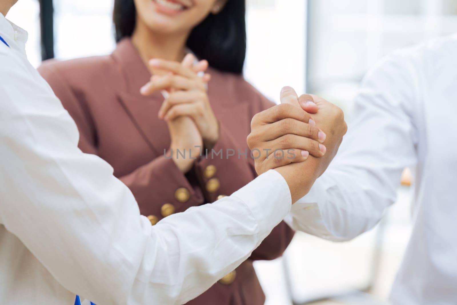 Closeup Handshake of employees after successful planning strategy marketing in the office by itchaznong