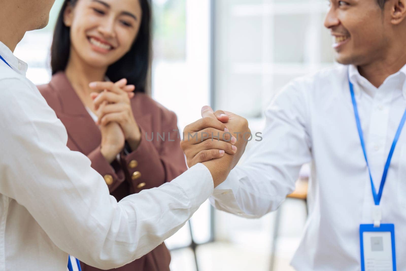 Closeup Handshake of employees after successful planning strategy marketing in the office.