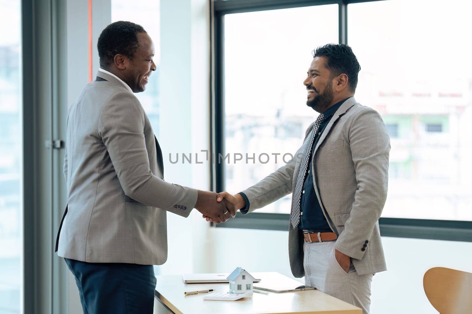 Real Estate agent and customer shaking hands after successful contract by itchaznong