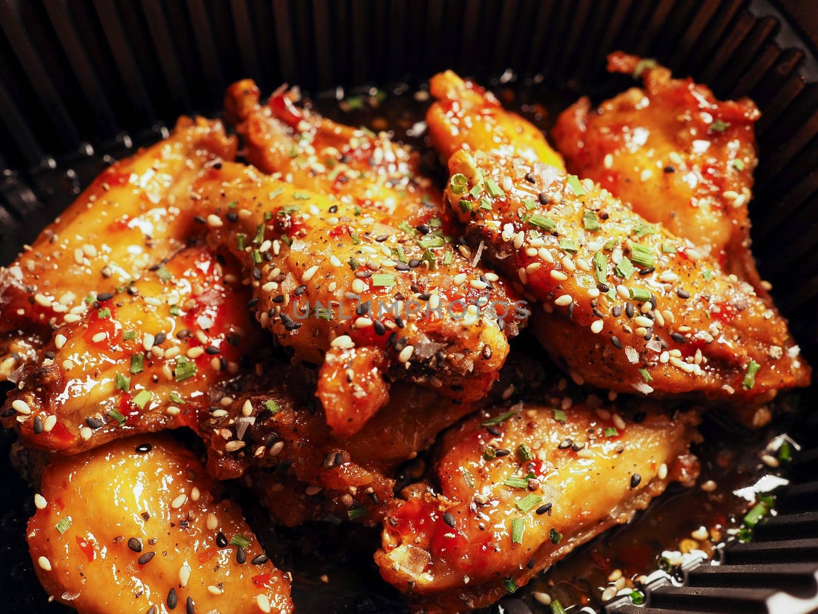 Close-up Korean Fried chicken Wings with sauce ans sesame. 치킨. Asian food.