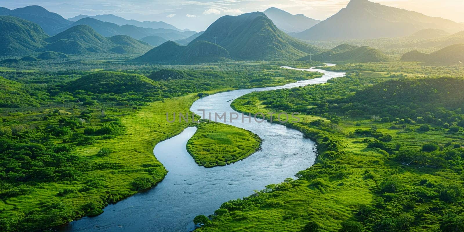 A meandering river winds its way through a vibrant green valley, surrounded by lush foliage and towering mountains in the distance.