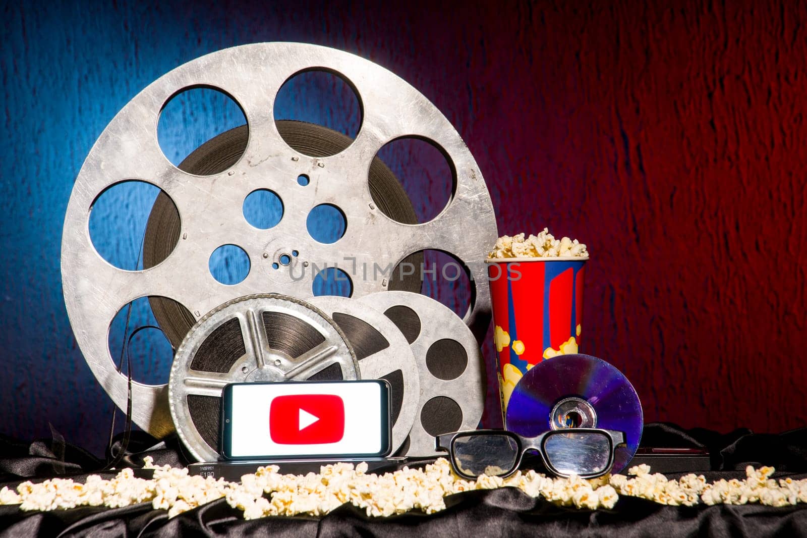 Tula, Russia - August 01,2020: Modern Smartphone with Youtube logo on old film reels background