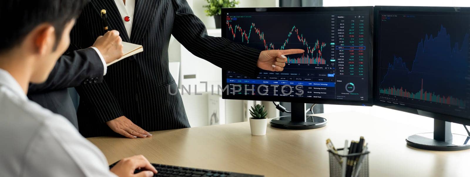 Group of profession trader discuss about stock market investment while point the increasing financial graph displayed on computer. Stock market investment concept Cropped image. Burgeoning.