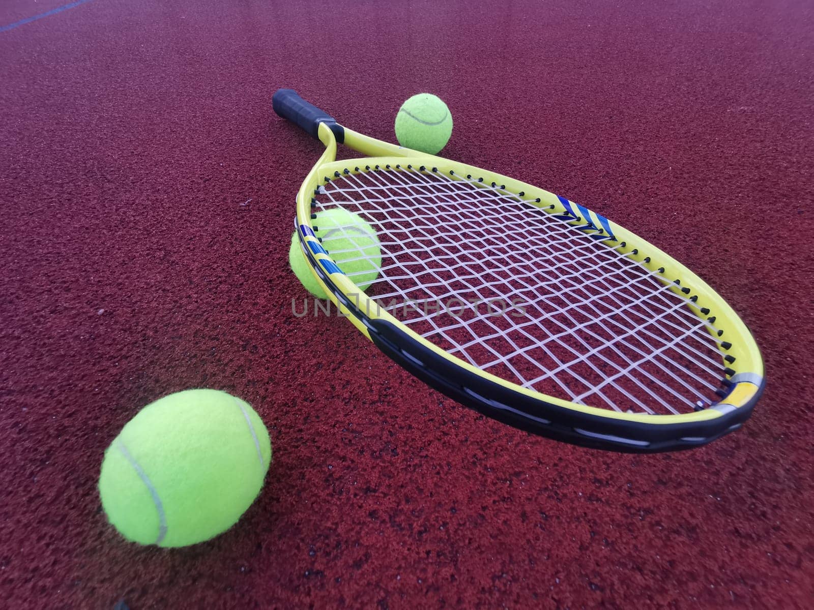 tennis racket with a tennis ball on a tennis court. High quality photo