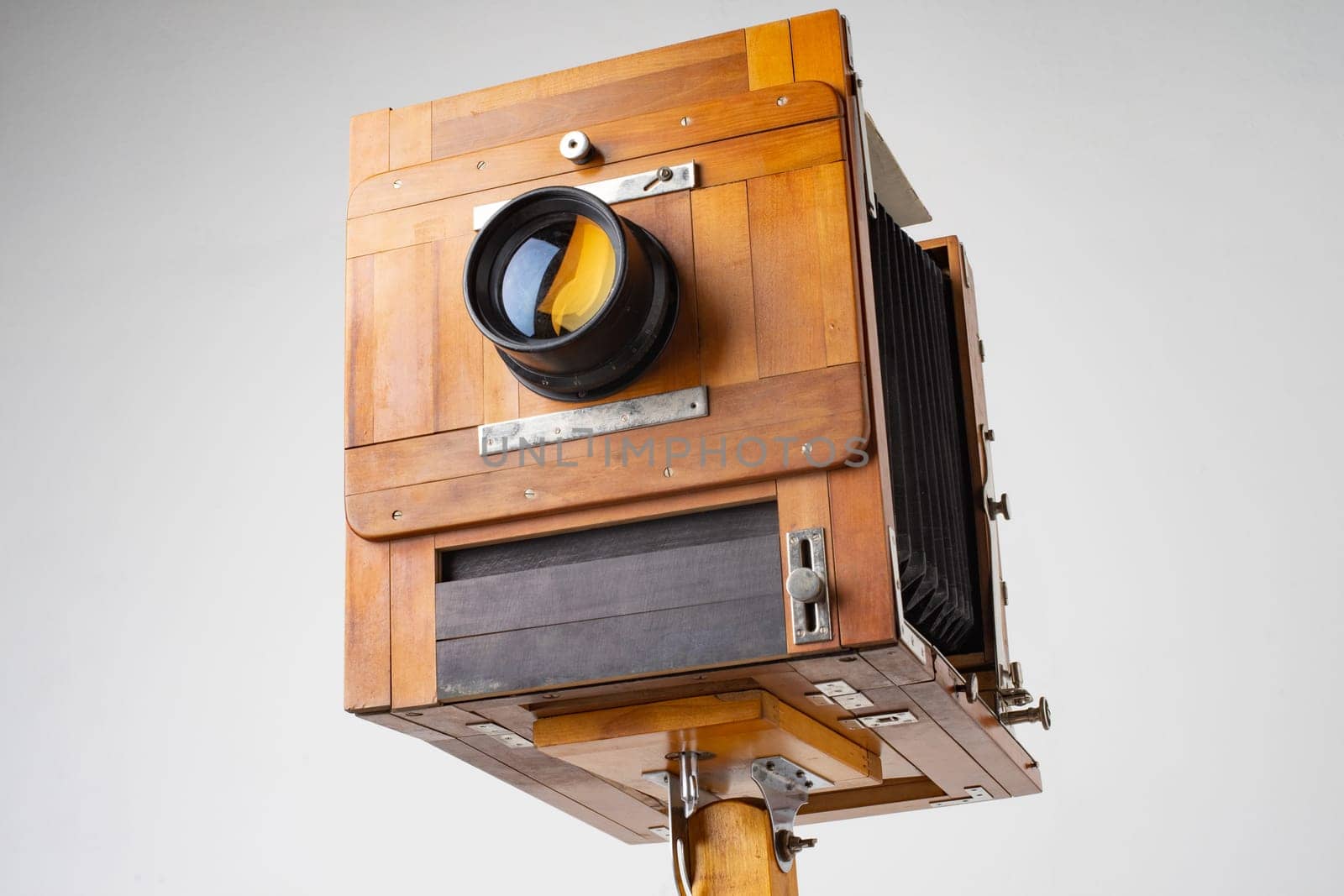 An old wooden camera of the last century with an accordion.