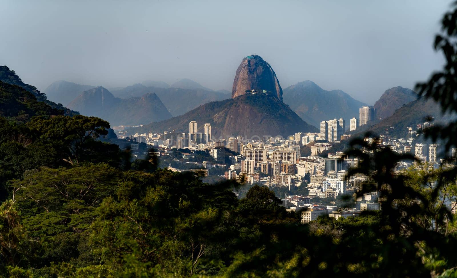 Distant View of Sugarloaf Mountain and Urca Hill in Rio de Janeiro Cityscape by FerradalFCG