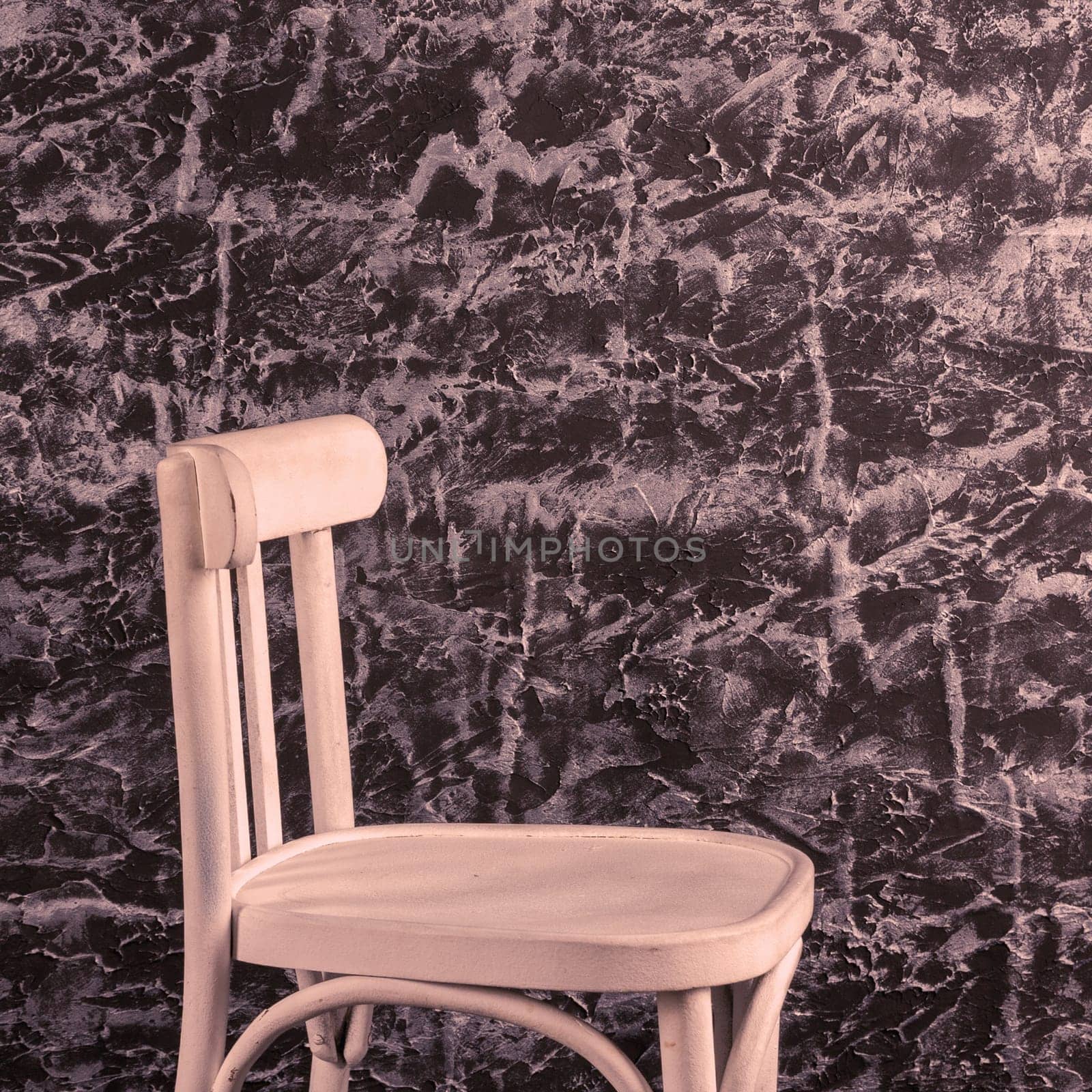 White chair near Texture decorative Venetian stucco wall