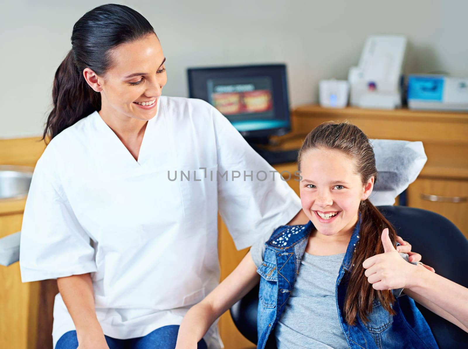 Dentist, portrait and girl with thumbs up for teeth whitening, results or oral care help. Face, smile and kid with woman doctor for tooth, wellness or dental, hygiene or braces, consultation and exam.