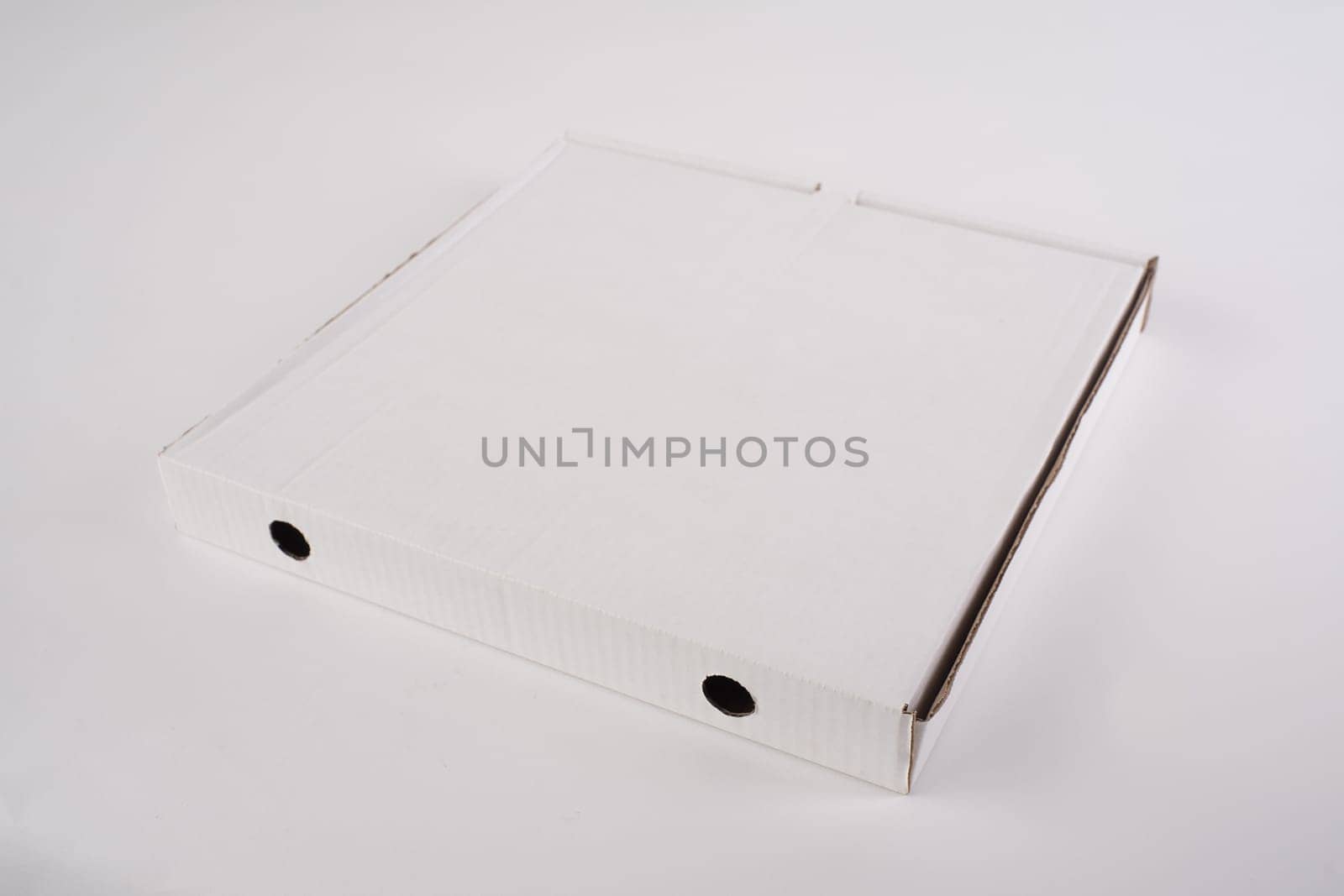 close up of a white pizza box template on white background.