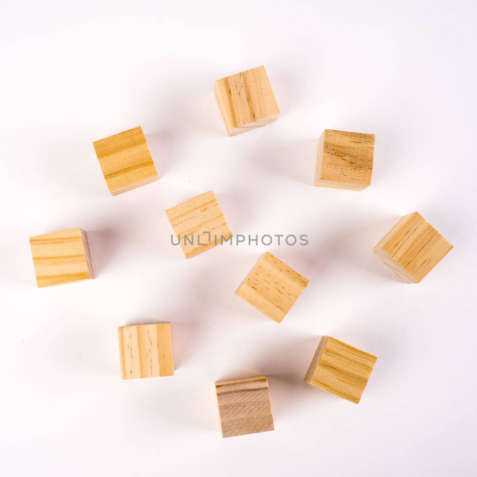 Row of ten blank wooden blocks on a white background with copyspace for your text, letters or numbers.